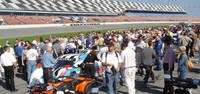 Fans crowd the pregrid of cars before the race