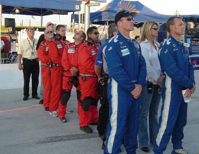 Randy and Shane and the crew stand at attention for the singng of the Star Spangle Banner